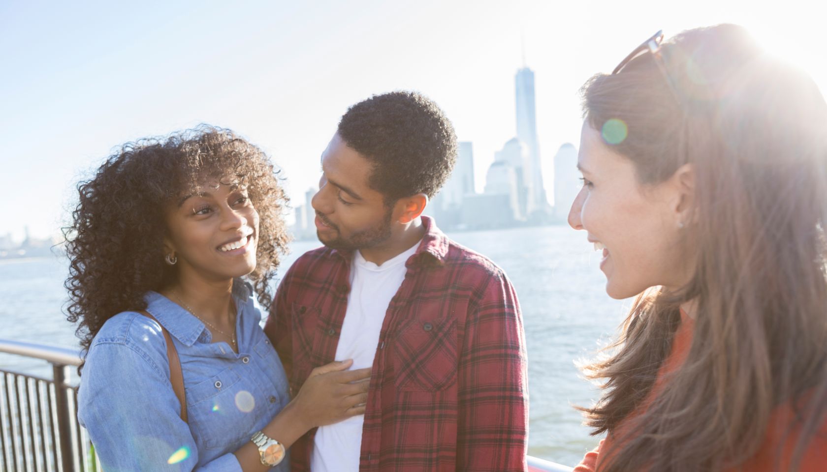 Young couple talk with female friend on vacation