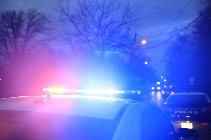 Police vehicles are parked at as police look for a person wanted on an arrest warrant in Bloomington, Indiana.