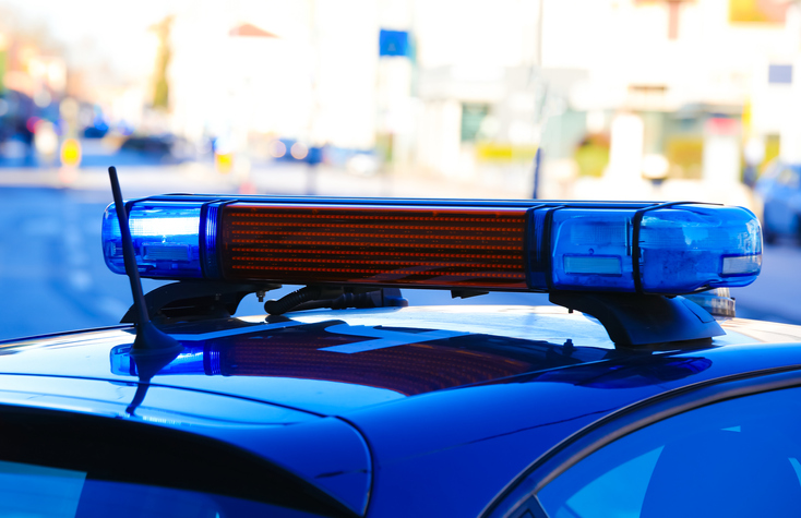 blue siren on the police car during control in the city streets