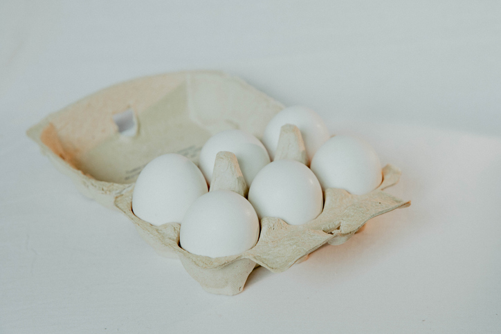 6 white eggs in a cardboard box