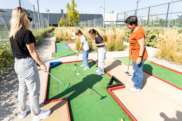 Minigolf player detail on green grass