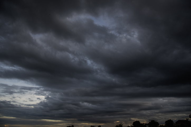 Dark rain cloud dramatic sky summer tropical thunder storm sky and fluffy black darkness cloud nearly raining cloudscape. Nimbus raincloud skyline climate background. Dark gray sky cloudy environment