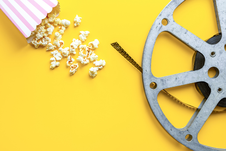 Cinema concept with film reels and popcorn. Movie background