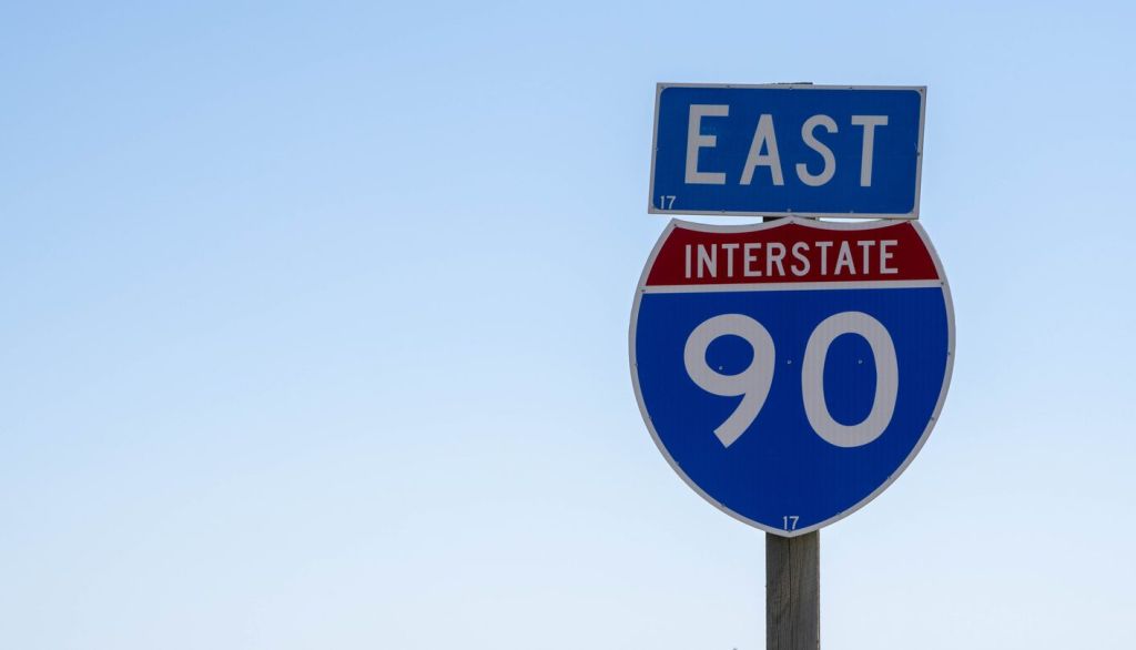 Interstate 90 East Highway Sign in Rural Landscape under Clear Blue Sky