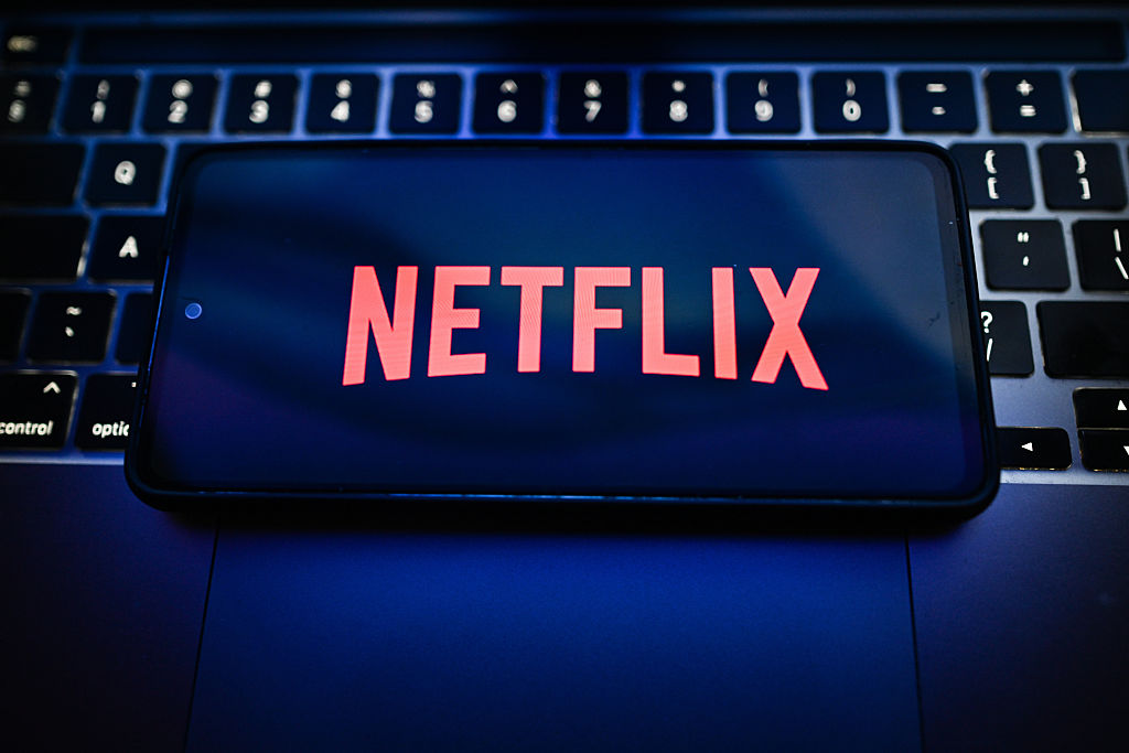 In this photo illustration, a Netflix logo is seen displayed
