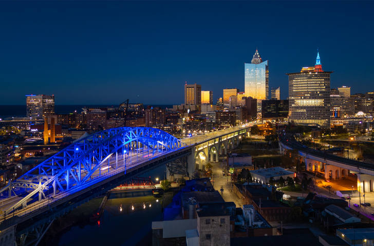 Cleveland Skyline At Dusk With Sunset Reflections And Illuminated Bridge