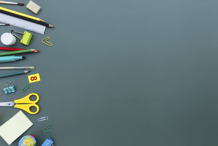 Back to school conceptual flat lay with different office supply objects and copy space area for text. Concept for primary and secondary school pupil. Scissors, pen, pencil, eraser, ruler, note, clip