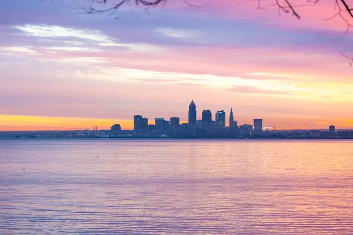 Vibrant Sunrise Silhouette of Cleveland Skyline over Lake Erie